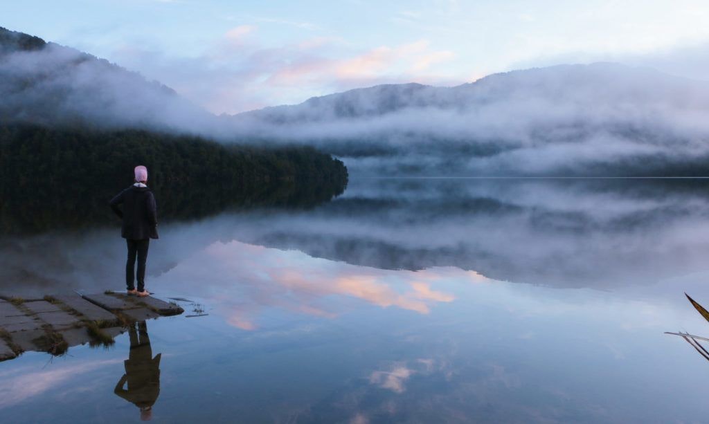 An entrepreneur looking across a lake on a cold day