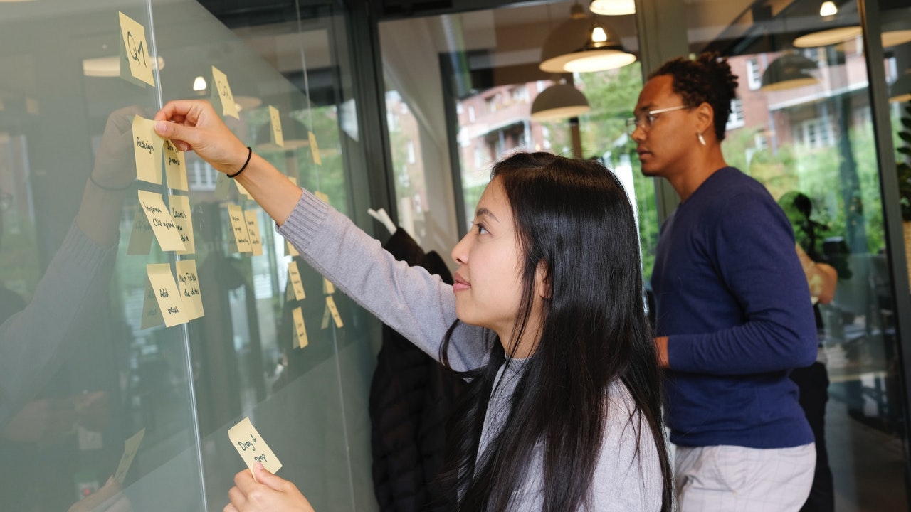 女孩在计划和粘贴便利贴