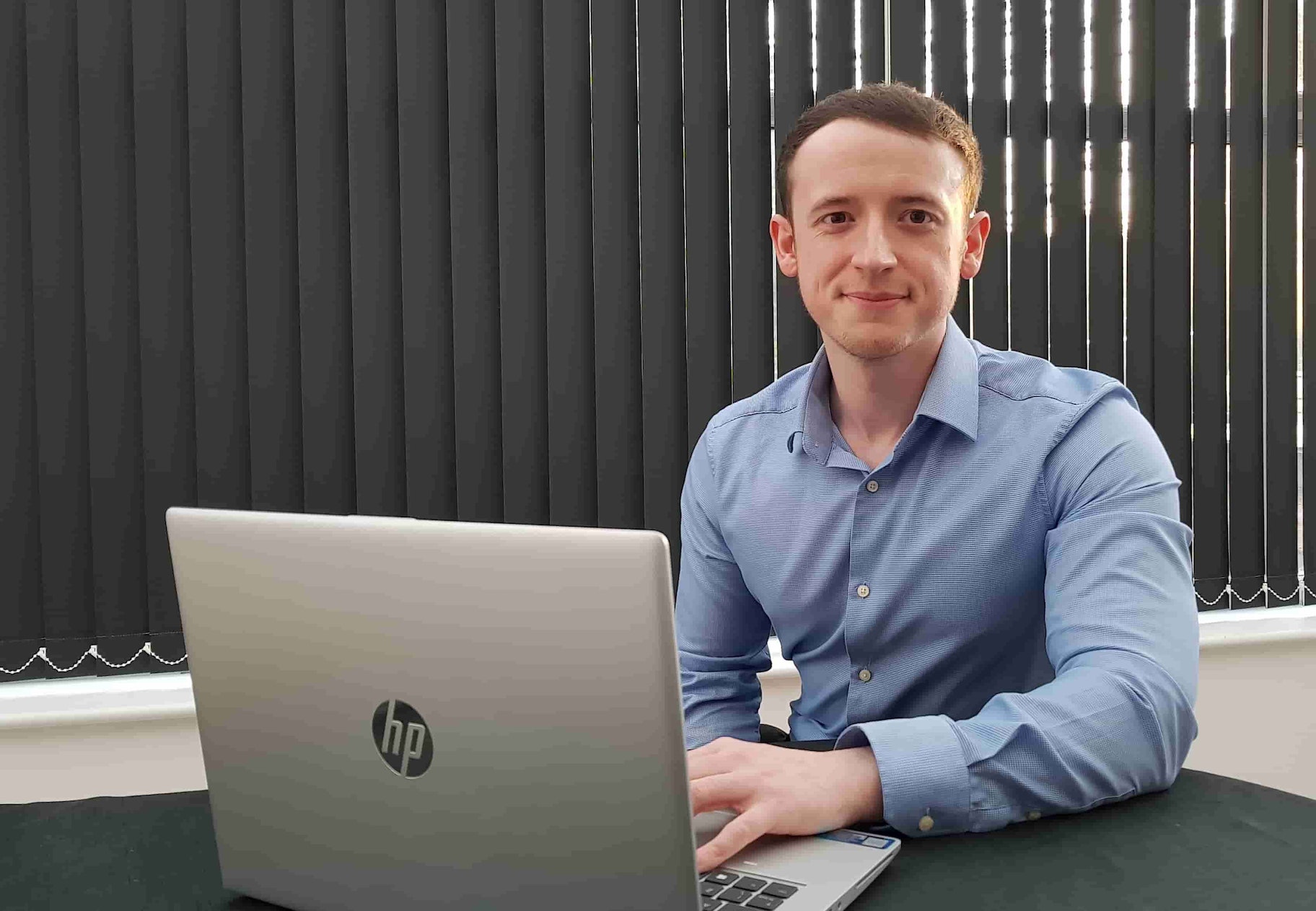 克里斯·韦恩坐在惠普笔记本电脑后面